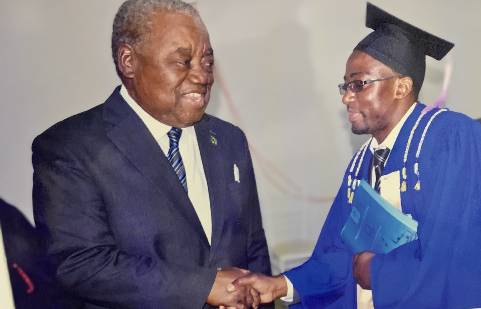 An Epiphany University Zambia graduate being congratulated at commencement